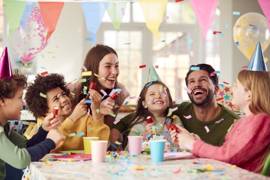 girl with parents friends home celebrating birthday firing confetti poppers party scaled 1 Inventory Hype